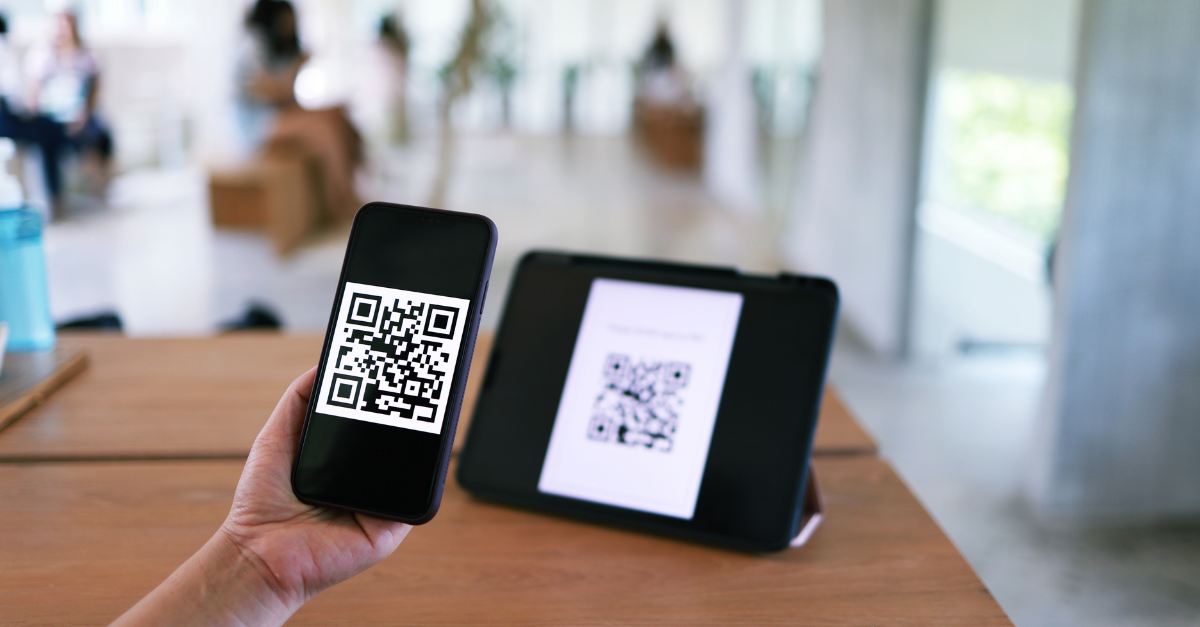 Person scanning QR code on tablet with iPhone 