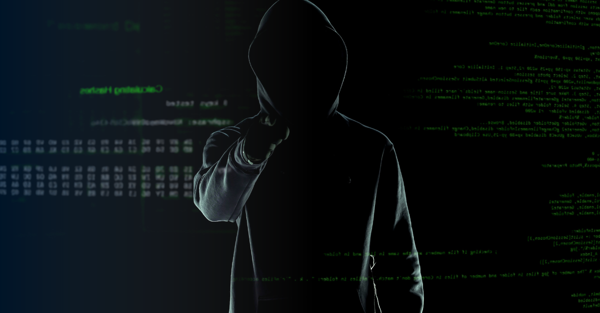 Dark hooded figure standing in front of code 