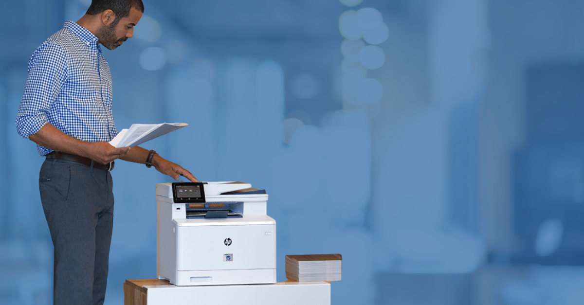 Man using TROY HP printer with blue background 