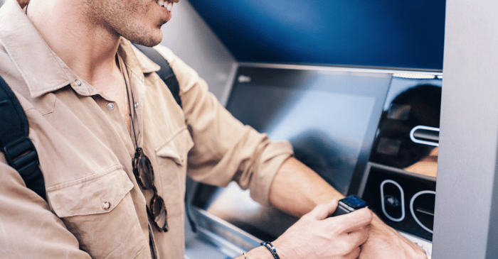 Man using ATM with smart watch 