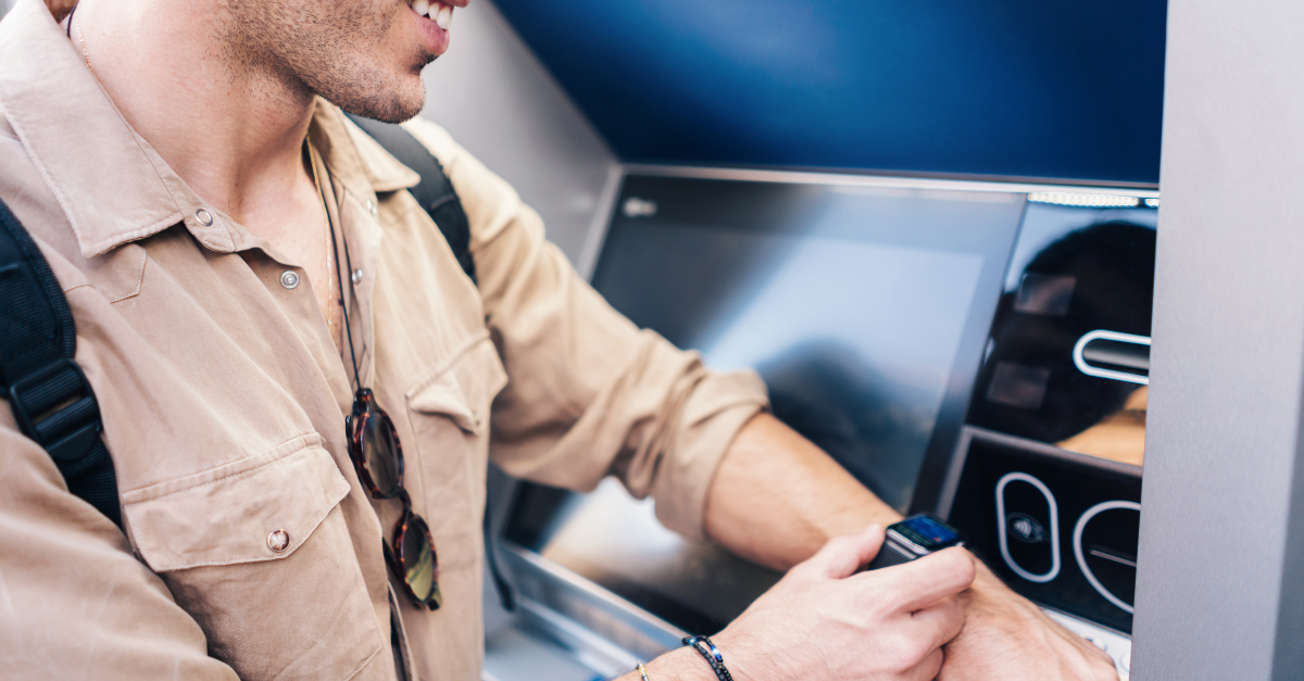 Man using ATM with wristwatch