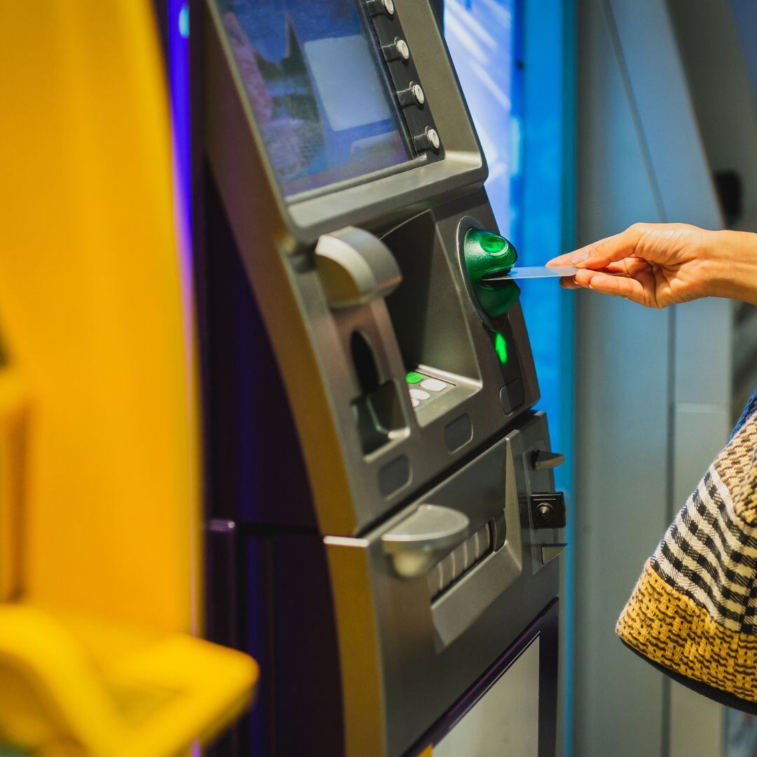 Person inserting card into ATM