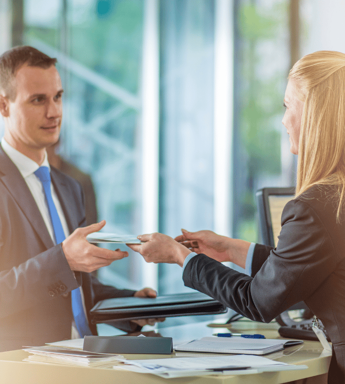 Bank teller handing check to man