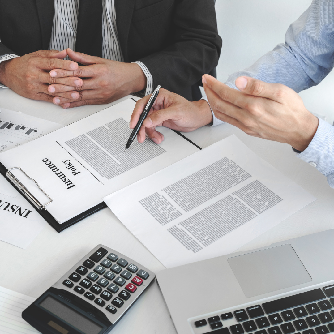 A group of people reviewing an insurance policy 