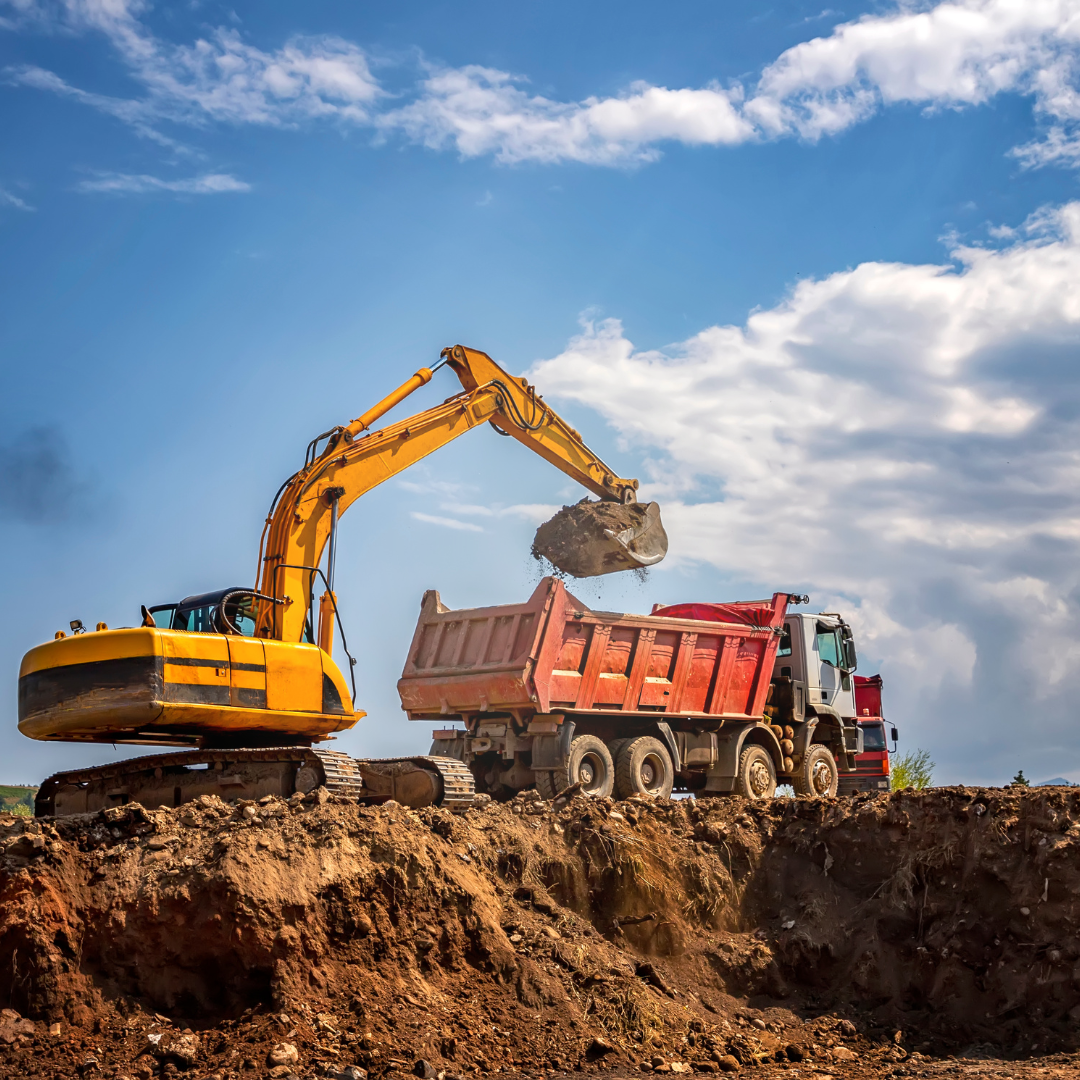 Construction vehicle loading into dump truck 