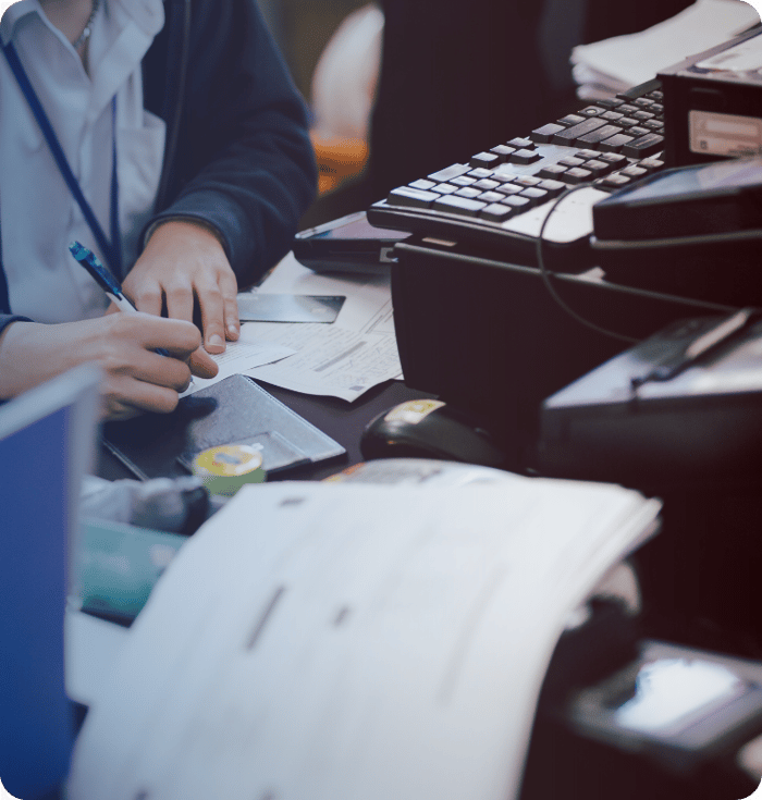 Woman at desk writing information on a check