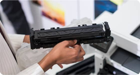 Woman cleaning a toner cartridge 