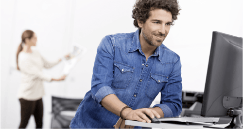 Man in blue button down shirt using computer