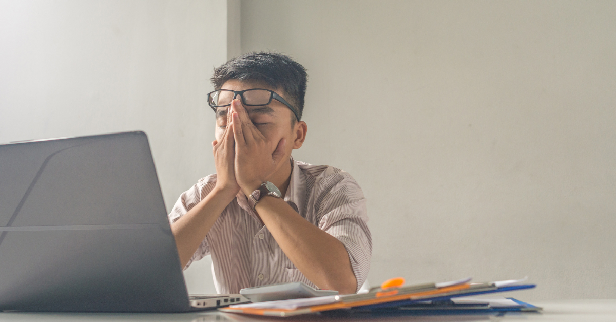 Frustrated man sitting at desk