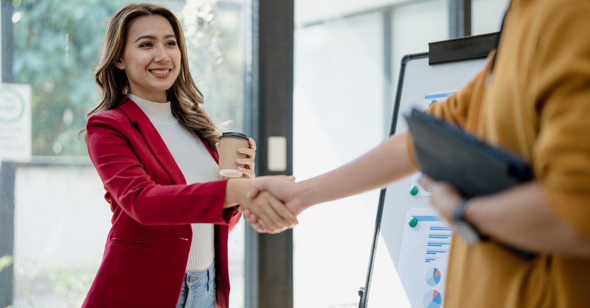 Woman shaking hands with a banking customer 