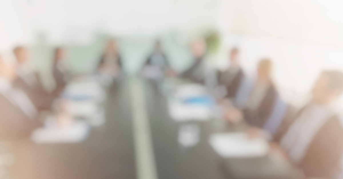 Blurred image of a board meeting