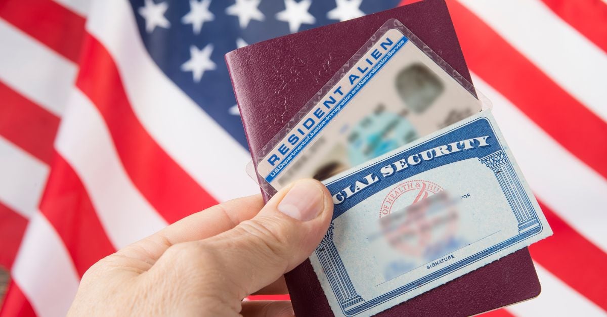 Social security card and license in front of american flag 