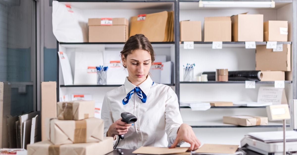 Woman scanning boxes at post office