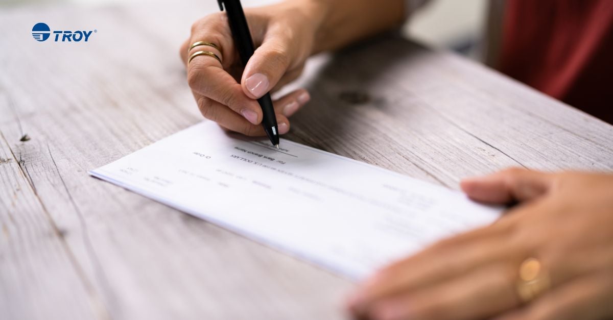 Person filing out fields on a check