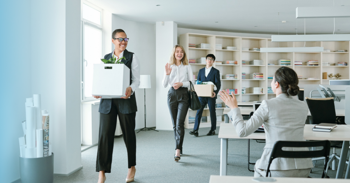 Employees returning to an office and being greeted by a coworker 